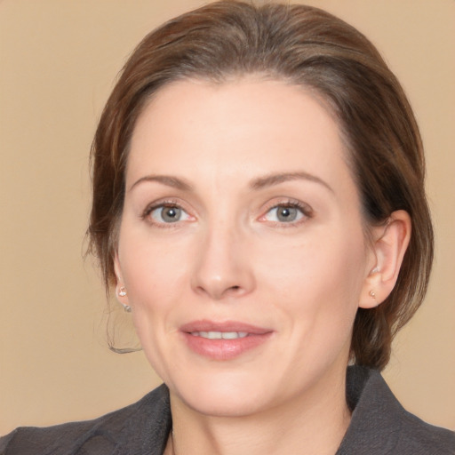 Joyful white adult female with medium  brown hair and brown eyes