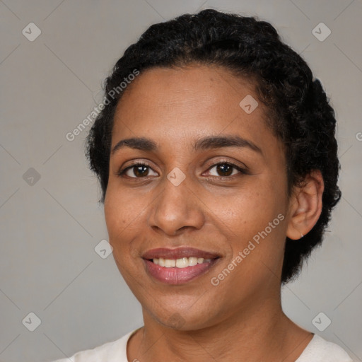 Joyful black young-adult female with short  black hair and brown eyes