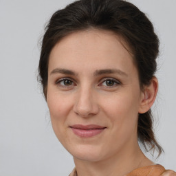 Joyful white young-adult female with medium  brown hair and brown eyes