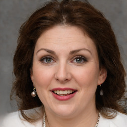 Joyful white young-adult female with medium  brown hair and green eyes