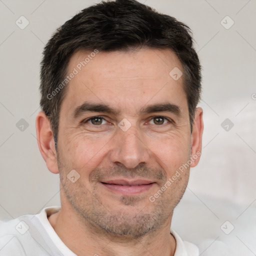 Joyful white adult male with short  black hair and brown eyes