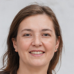 Joyful white adult female with medium  brown hair and grey eyes