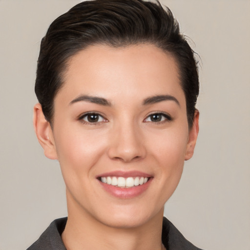 Joyful white young-adult female with short  brown hair and brown eyes