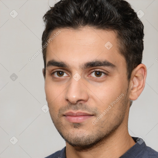 Joyful white young-adult male with short  black hair and brown eyes