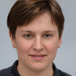 Joyful white young-adult female with short  brown hair and grey eyes