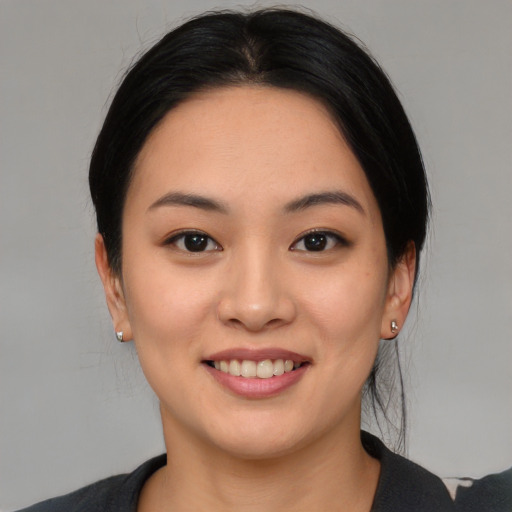 Joyful asian young-adult female with medium  black hair and brown eyes