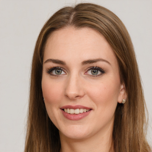 Joyful white young-adult female with long  brown hair and green eyes