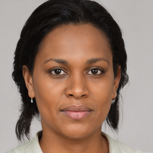 Joyful latino young-adult female with medium  black hair and brown eyes