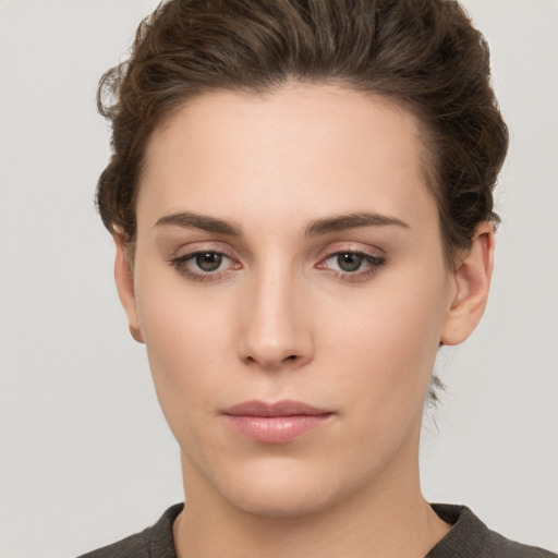 Neutral white young-adult female with short  brown hair and brown eyes