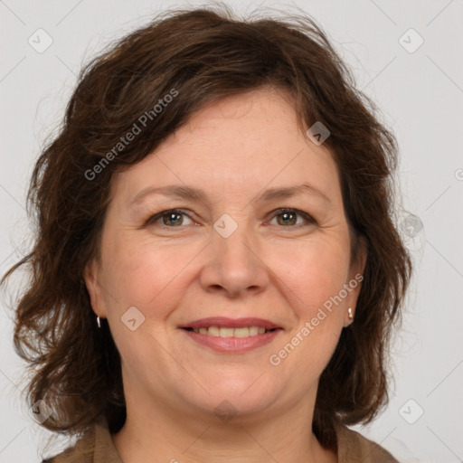 Joyful white adult female with medium  brown hair and green eyes