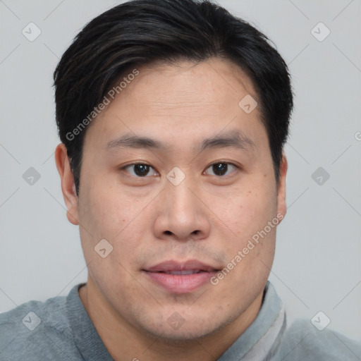 Joyful asian young-adult male with short  brown hair and brown eyes