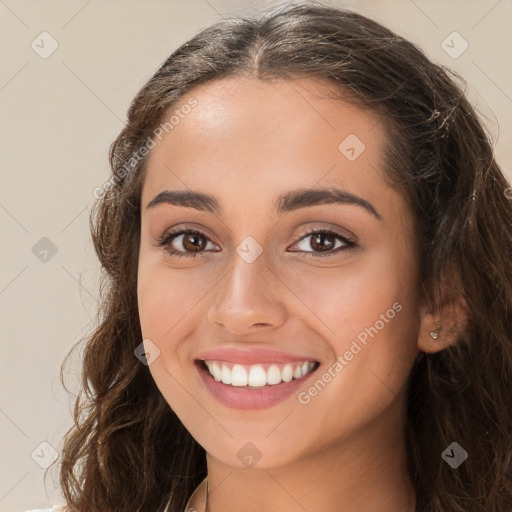 Joyful white young-adult female with long  brown hair and brown eyes