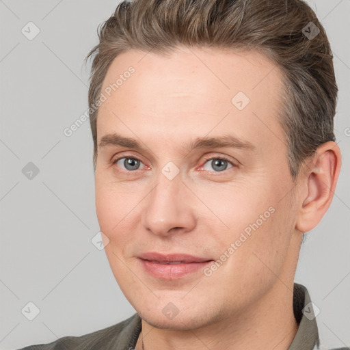 Joyful white adult male with short  brown hair and brown eyes