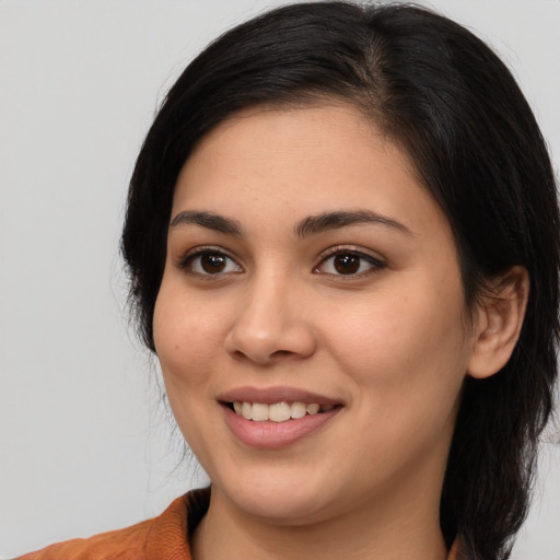 Joyful white young-adult female with medium  black hair and brown eyes