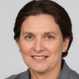 Joyful white adult female with medium  brown hair and grey eyes