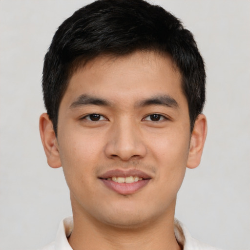 Joyful asian young-adult male with short  brown hair and brown eyes