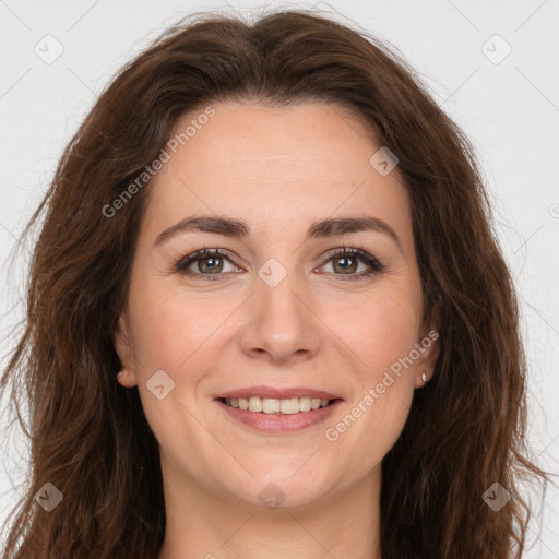 Joyful white adult female with long  brown hair and brown eyes