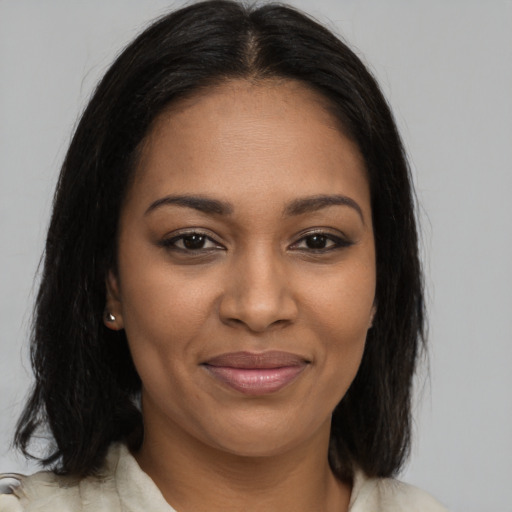 Joyful black young-adult female with medium  brown hair and brown eyes