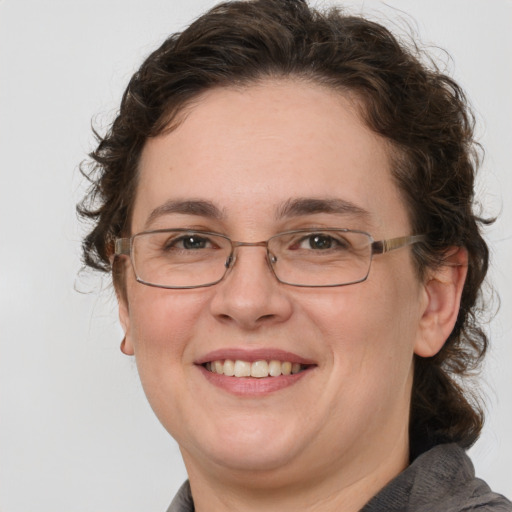 Joyful white adult female with short  brown hair and grey eyes