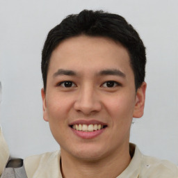 Joyful white young-adult male with short  black hair and brown eyes