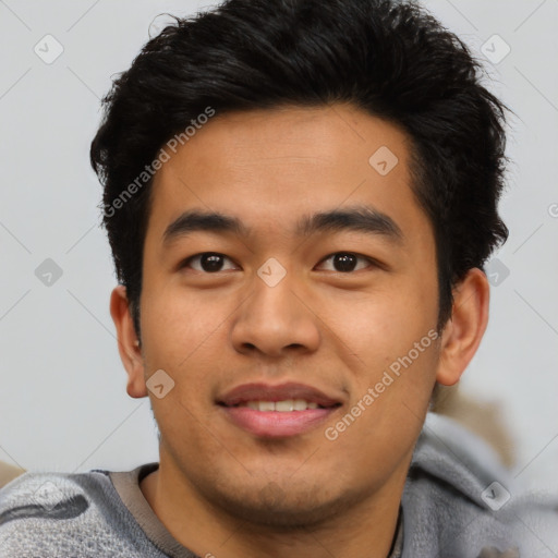 Joyful asian young-adult male with short  black hair and brown eyes