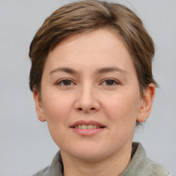 Joyful white young-adult female with short  brown hair and grey eyes