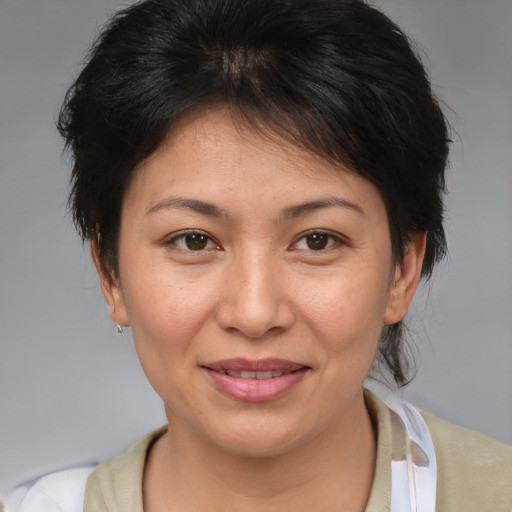 Joyful asian adult female with medium  brown hair and brown eyes