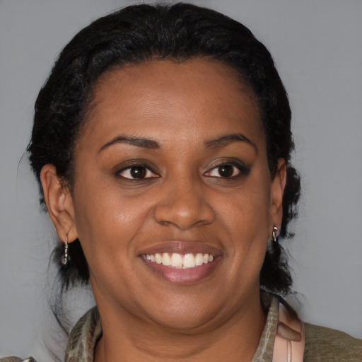 Joyful black adult female with medium  brown hair and brown eyes