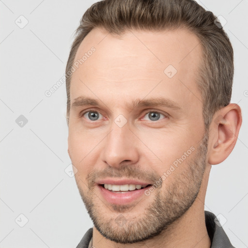 Joyful white adult male with short  brown hair and brown eyes