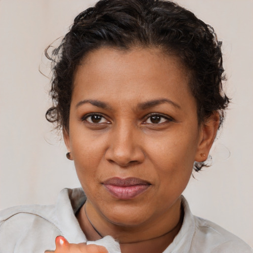 Joyful black adult female with short  brown hair and brown eyes