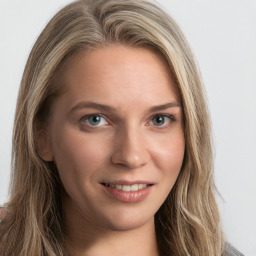 Joyful white young-adult female with long  brown hair and green eyes