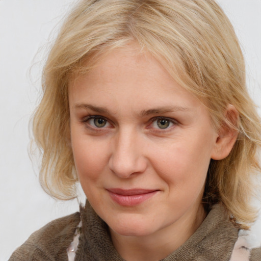 Joyful white young-adult female with medium  brown hair and blue eyes