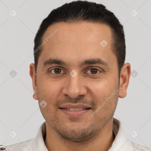 Joyful white young-adult male with short  black hair and brown eyes