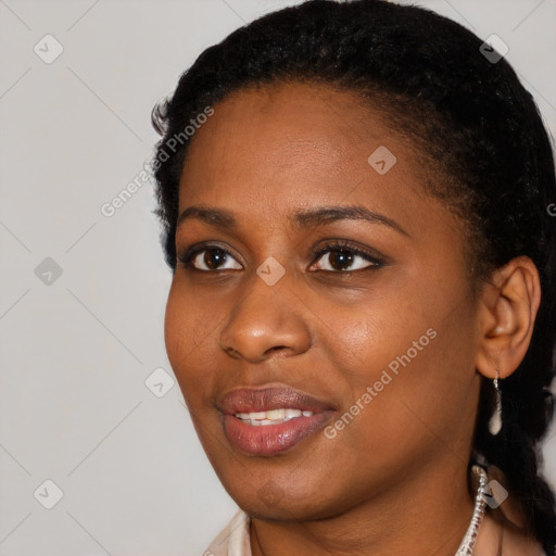 Joyful black young-adult female with short  brown hair and brown eyes