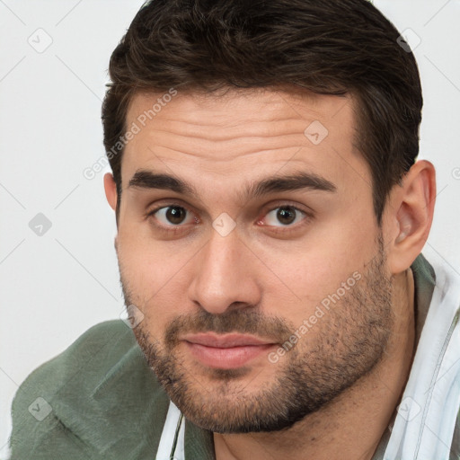 Joyful white young-adult male with short  brown hair and brown eyes