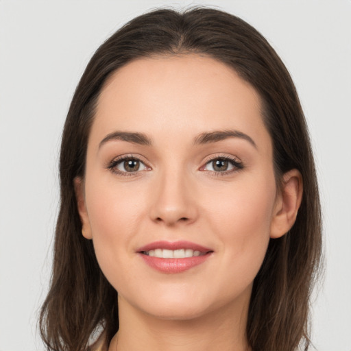 Joyful white young-adult female with long  brown hair and brown eyes