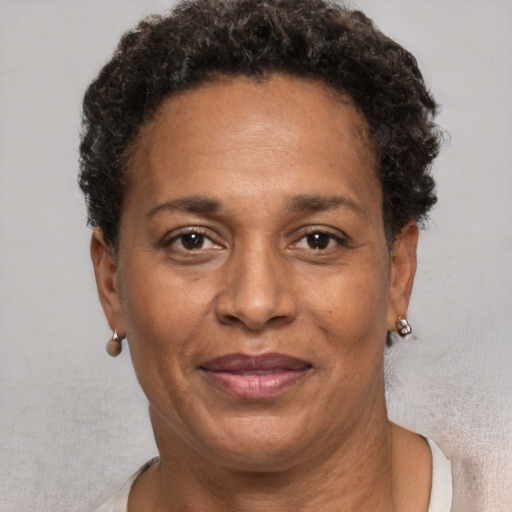 Joyful black adult female with short  brown hair and brown eyes