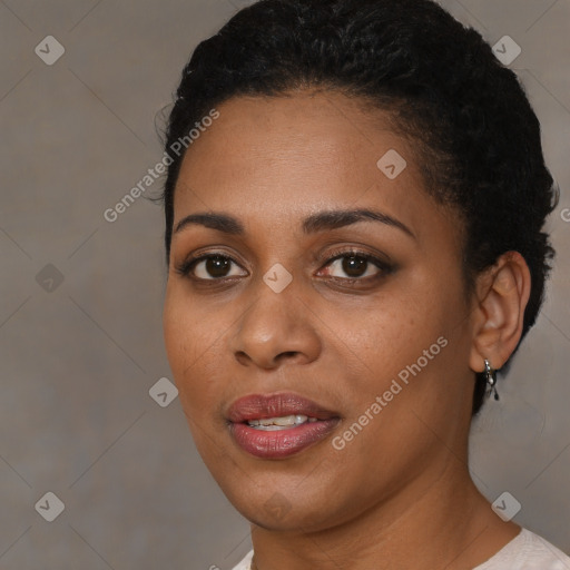 Joyful black young-adult female with short  brown hair and brown eyes