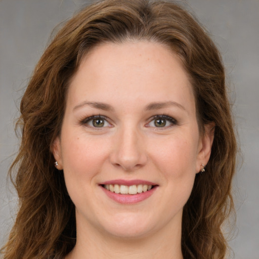 Joyful white young-adult female with long  brown hair and green eyes