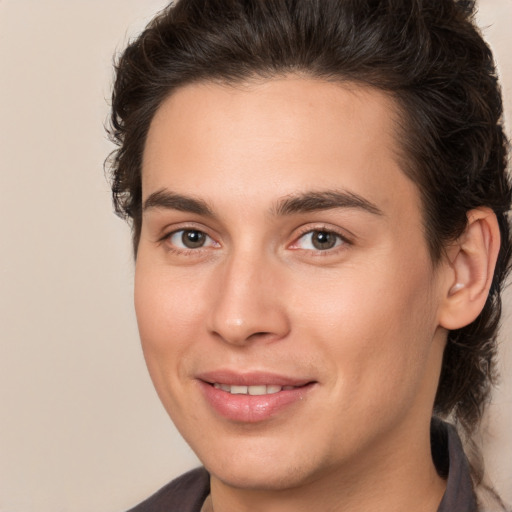 Joyful white young-adult male with medium  brown hair and brown eyes