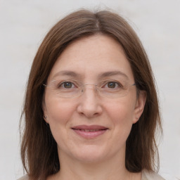 Joyful white adult female with medium  brown hair and grey eyes