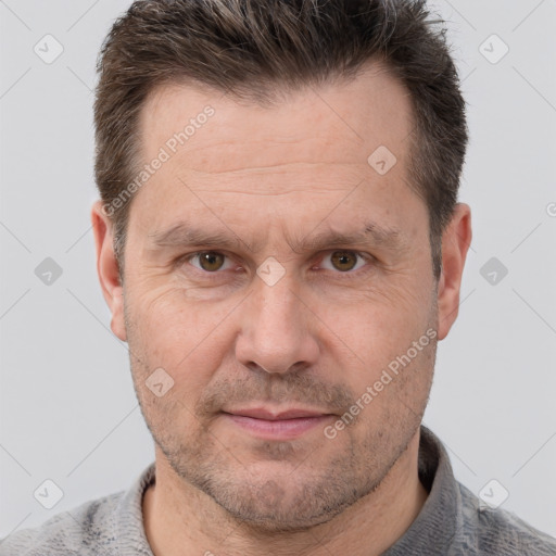 Joyful white adult male with short  brown hair and grey eyes