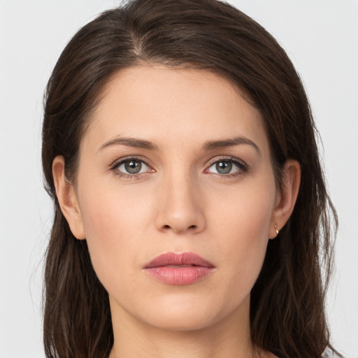 Joyful white young-adult female with long  brown hair and grey eyes