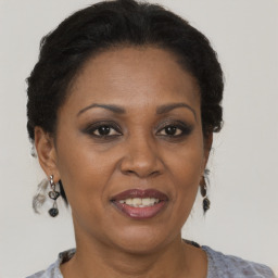 Joyful black adult female with short  brown hair and brown eyes