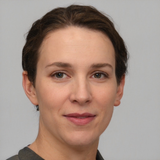 Joyful white adult female with short  brown hair and grey eyes