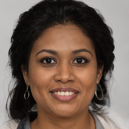 Joyful black young-adult female with medium  brown hair and brown eyes