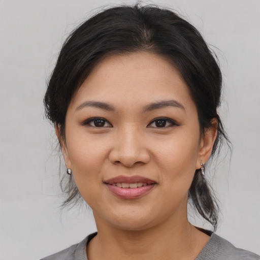 Joyful asian young-adult female with medium  brown hair and brown eyes