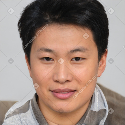 Joyful asian young-adult male with short  brown hair and brown eyes