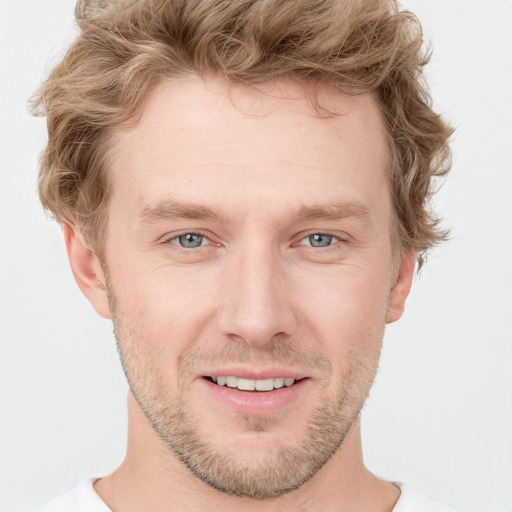 Joyful white young-adult male with short  brown hair and blue eyes