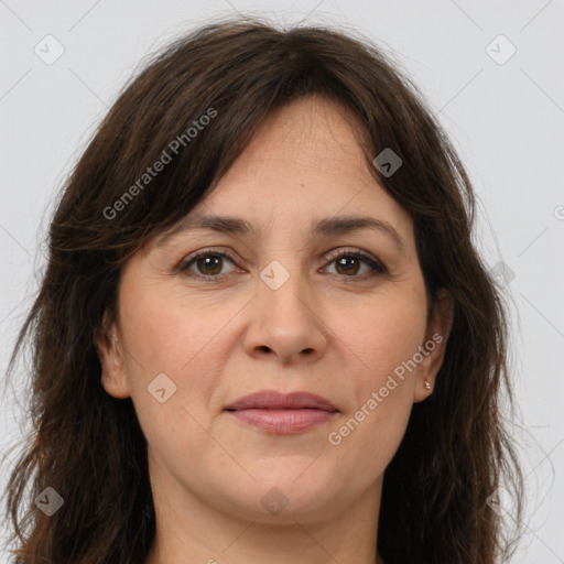 Joyful white adult female with long  brown hair and brown eyes